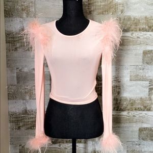 Pink feathers on shoulders an wrist see threw top